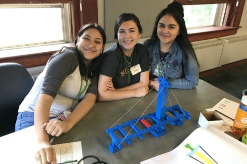 Girls with a model at the women in construction management camp