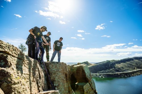 students rock climbing near horestooth reservoir
