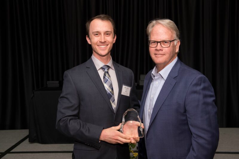 Micah Battson accepting award with Dean Jeff McCubbin