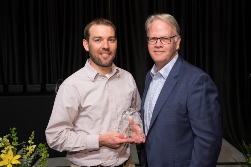 Jon Elliott accepting award with Dean Jeff McCubbin