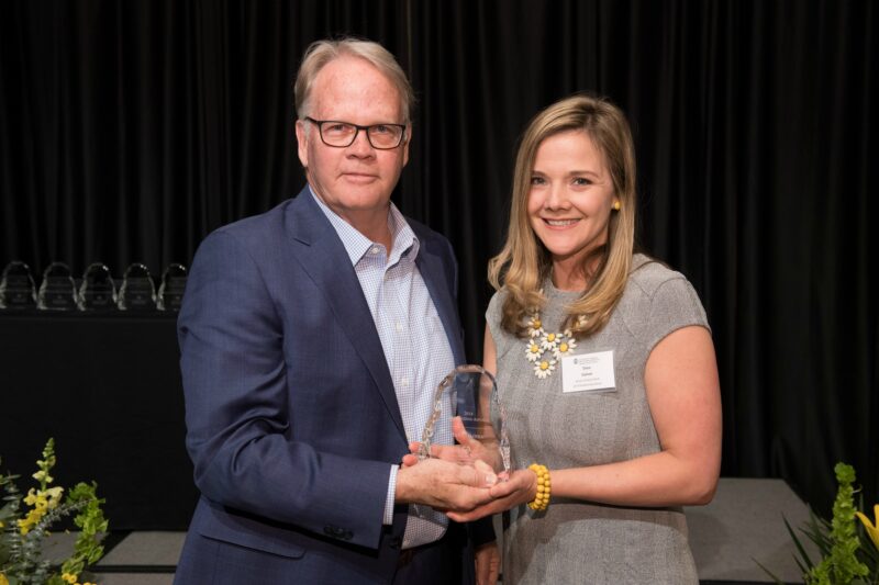 Dana Gaines accepting award with Dean Jeff McCubbin