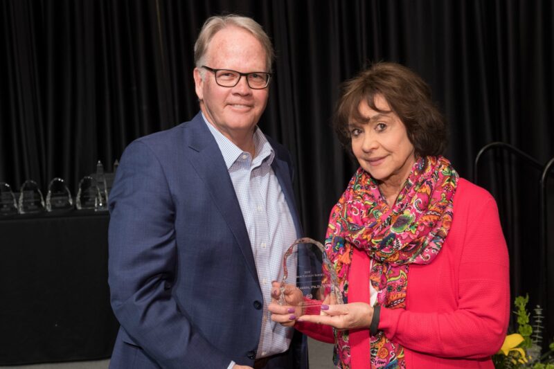 Mary Harris accepting award with Dean Jeff McCubbin