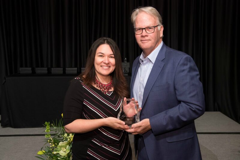 Susana Muñoz accepting award with Dean Jeff McCubbin
