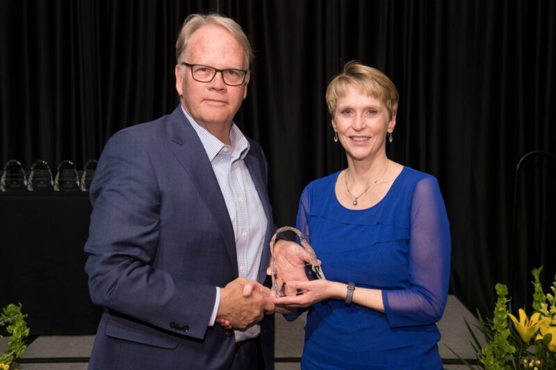 Jackie Peila-Shuster accepting award with Dean Jeff McCubbin