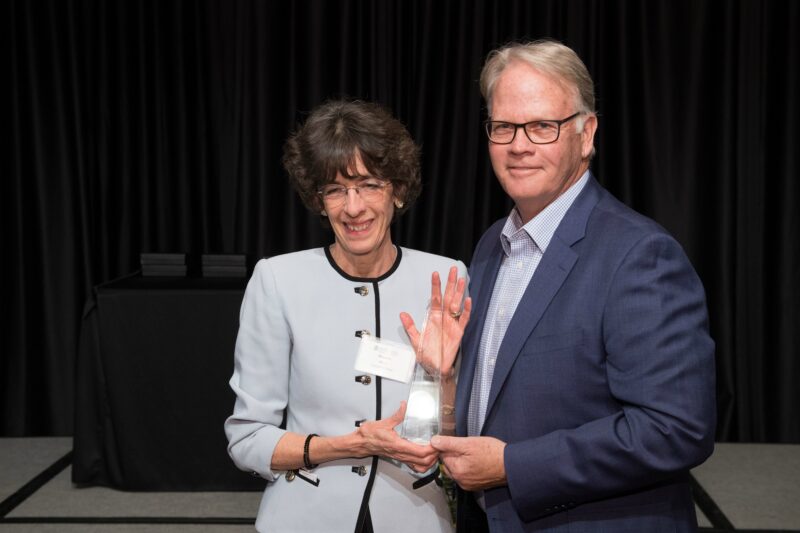 Marcella Wells accepting award with Dean Jeff McCubbin