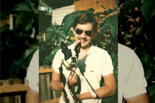 A young Craig Birdsong holding a dog