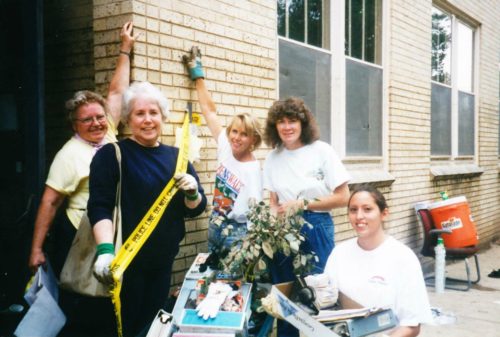 Janell Prussman and Dean's Office employees cleaning up after the flood