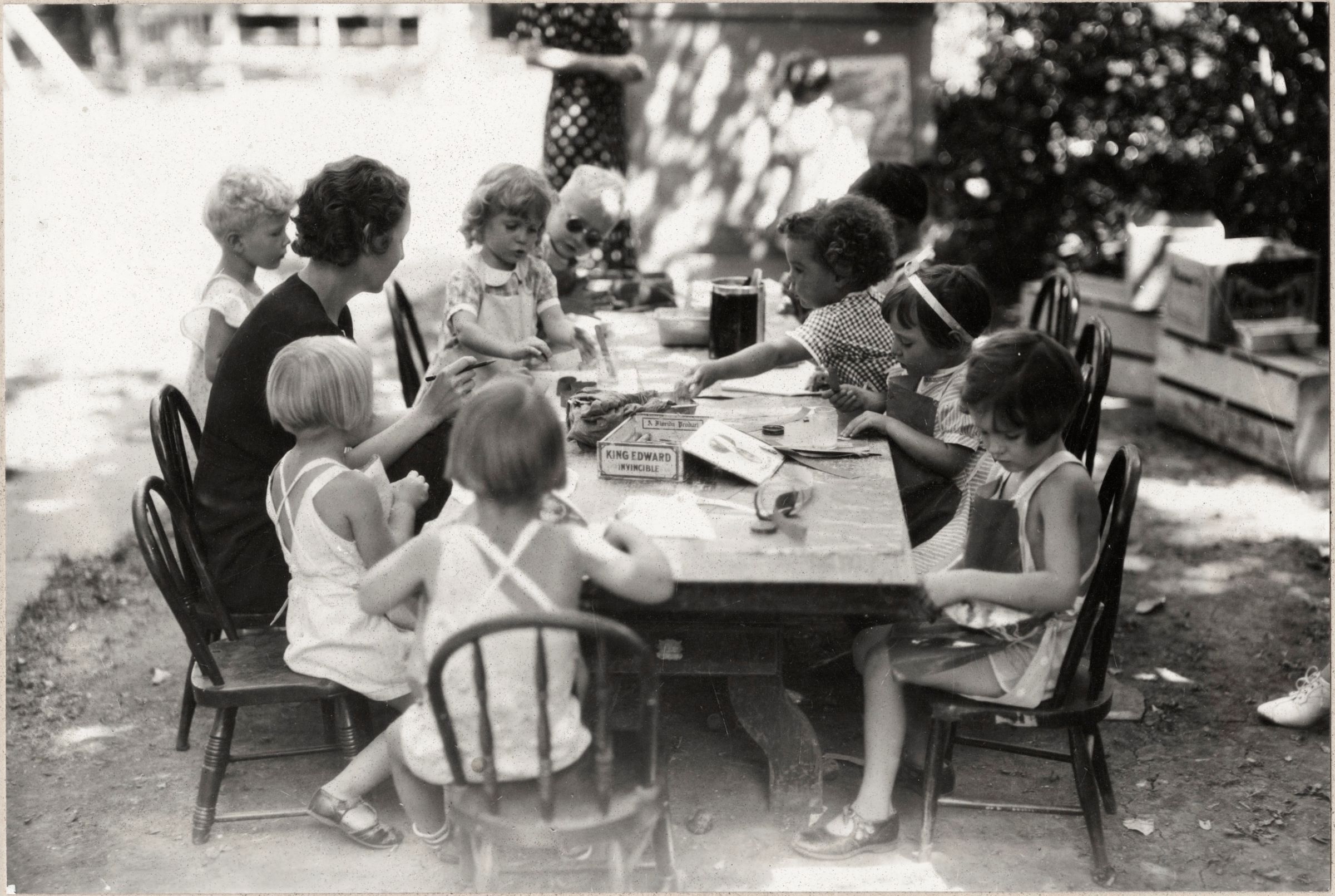 Small children sitting around a craft table.