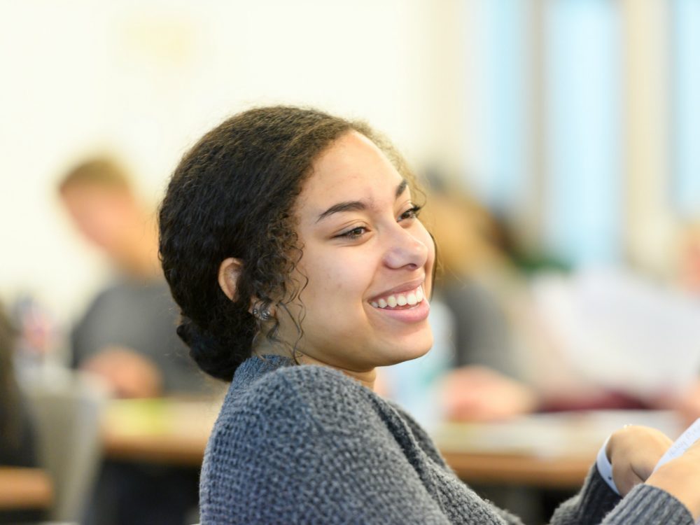 Student smiling in a classroom