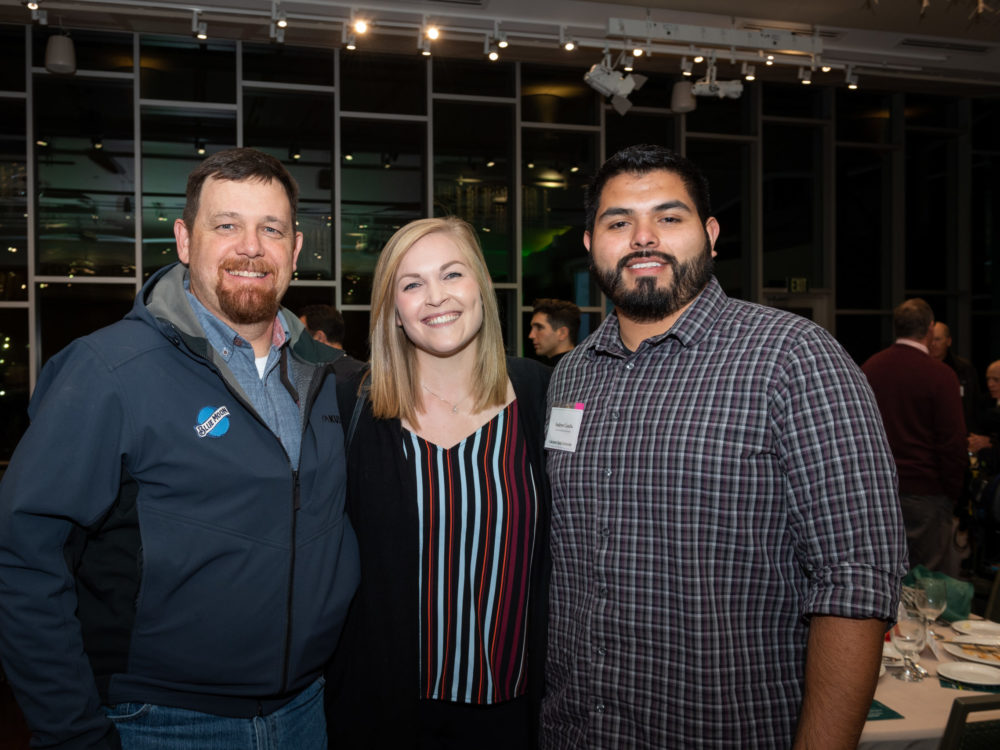 Kelsey Burket (middle) smiles for a photo with two men at a scholarship event in the CSU Lory Student Center Ballroom.