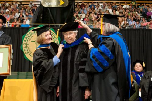 Nancy hooding an honoree at an honoree degree ceremony