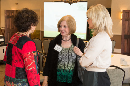 Nancy Hartley at an event speaking to Myra Powers and Dawn Mallette