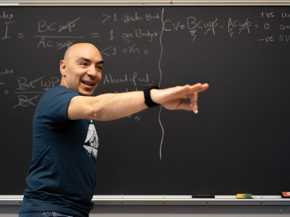 Mohammed Mehany in front of a blackboard teaching