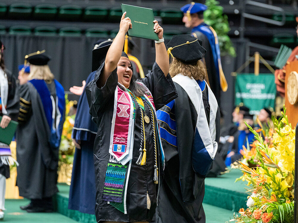 Student celebrating at the College of Health and Human Sciences Fall Commencement, December 17, 2022