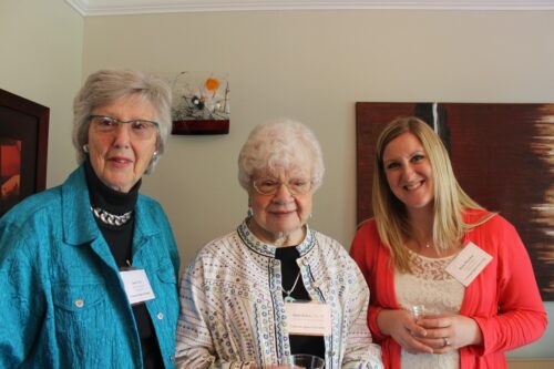 Janet Fritz, Anne Kylen, and Katie Brayden standing together at an event in a home