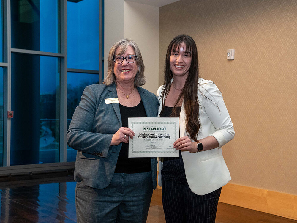 Lise Youngblade presenting Karime Marrufo Legarda with the Distinction in Creative Artistry and Scholarship - Graduate Student award at Research Day 2024