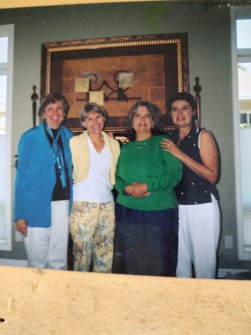 Jodie Hanzlik standing with three other women in front of a painting
