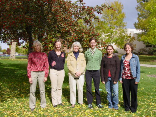 Vicky Buchan an outdoor group photo standing in front of a tree with five others