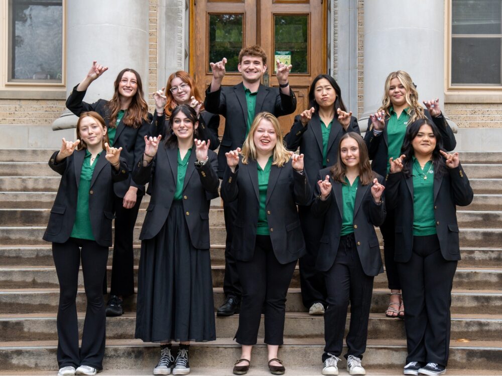 The Dean's Ambassador Program members smile while on the stairs of the CSU Administration Building