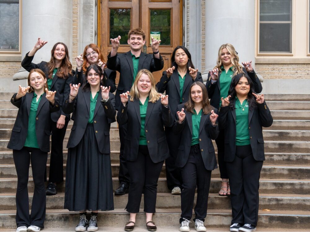 The Dean's Ambassador Program members smile while on the stairs of the CSU Administration Building