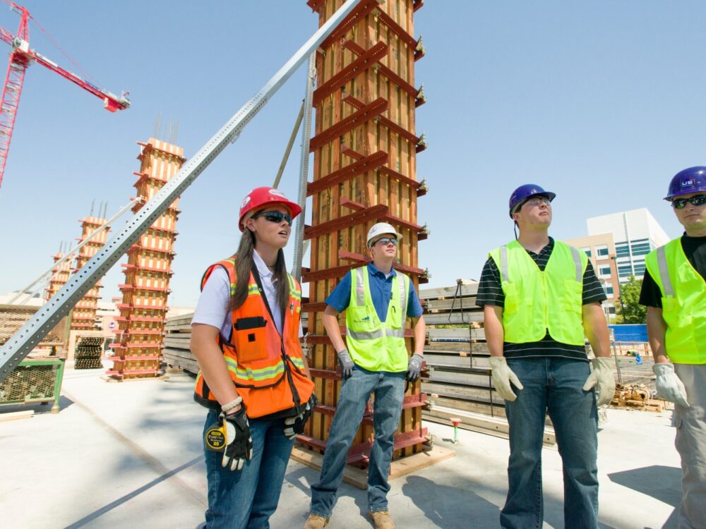 A group of people in safety gear on a construction site